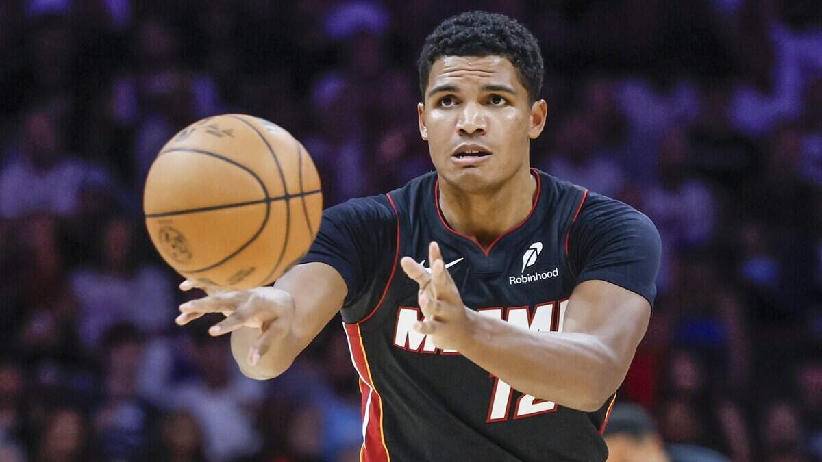 Miami Heat guard Dru Smith (12) passes the ball during the first half of the NBA basketball game against the New York Knicks at Kaseya Center in Miami on October 26, 2025.