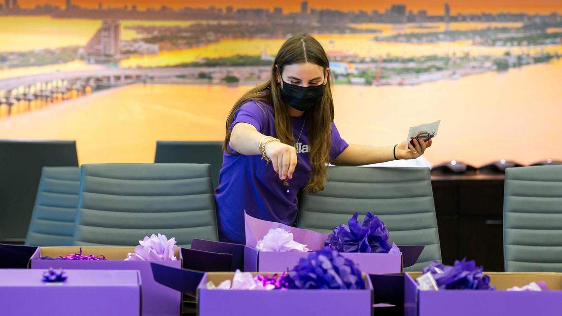 Miami Foundation employee Nicky Zarchen prepares Give Miami Day goody boxes at the Foundation’s offices in downtown Miami on Wednesday, Nov. 10, 2021. The boxes, which included items like coffee, stickers, sunglasses, beaded necklaces, fans, candy, and more, are to remind their friends, business and local leaders about Give Miami Day, which happens on Nov. 18, 2021.
