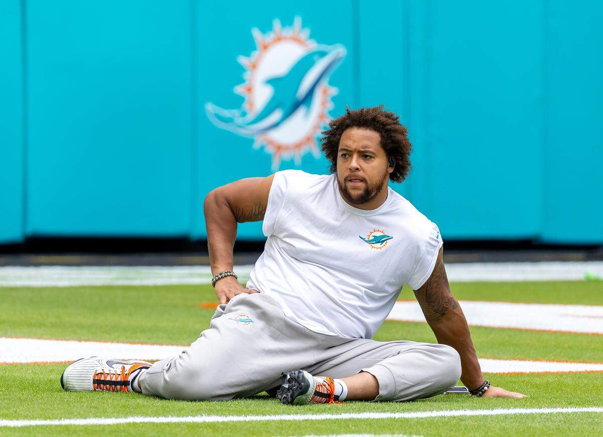 Miami Dolphins offensive tackle Kendall Lamm (70) stretches on the field before the start of their NFL game against the Las Vegas Raiders at Hard Rock Stadium on Sunday, Nov. 17, 2024, in Miami Gardens, Fla