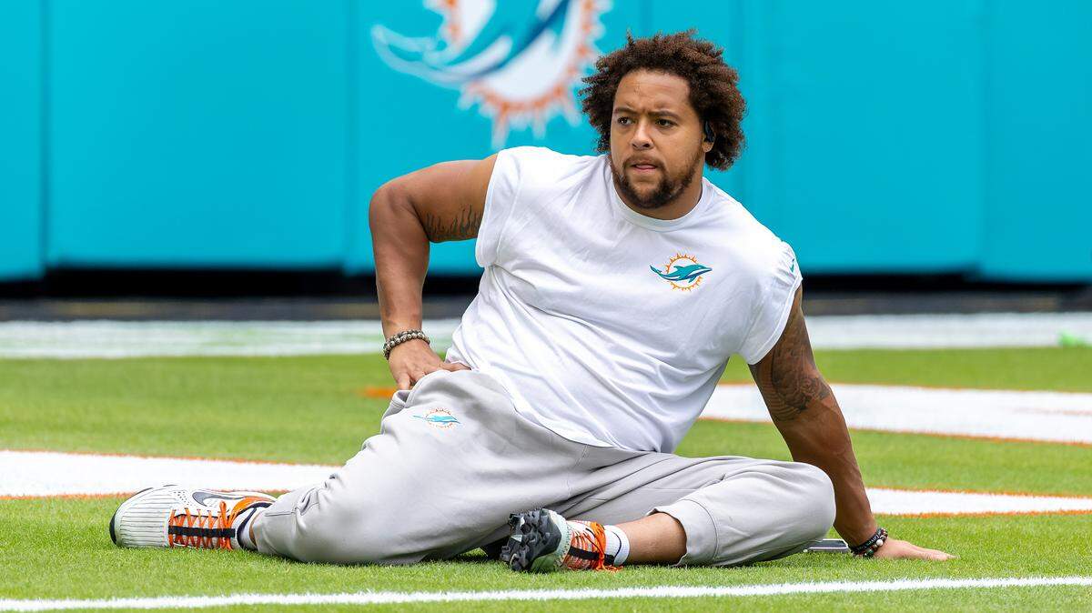 Miami Dolphins offensive tackle Kendall Lamm (70)  stretches on the field before the start of their NFL game against the Las Vegas Raiders at Hard Rock Stadium on Sunday, Nov. 17, 2024, in Miami Gardens, Fla