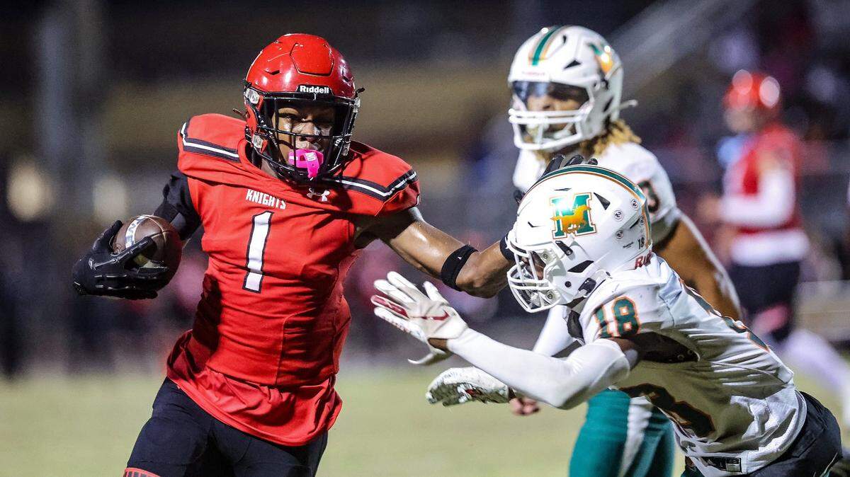 Monarch Knights Jabari Brady, wide receiver (1), carries the ball, against Mandarin’s Joshua Burton cornerback (18), during the state semifinal football game against the Mandarin Mustangs, at Coconut Creek High School, on Friday December 01, 2023.