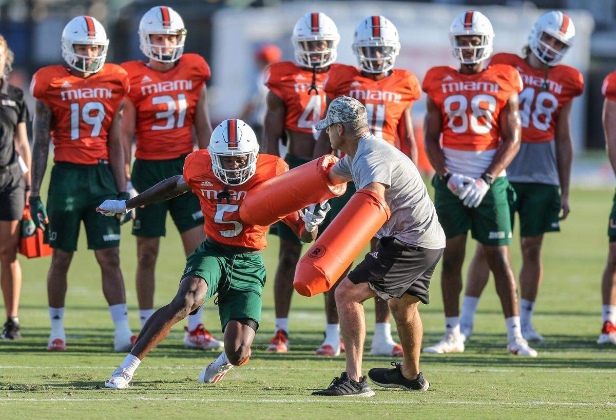 Miami Hurricanes assistant coach, passing game coordinator and wide receivers, Rob Likens, works with wide receiver Keyshawn Smith (5) during practice at the University of Miami’s Greentree Practice Field in Coral Gables on Thursday, August 19, 2021.