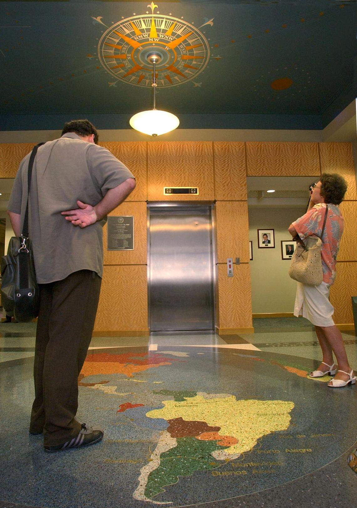 The cityy of Miami and The Dade Heritage Trust held a restoration celebration at Miami City Hall, 3500 Pan American Drive. Built originally in 1934 as the Pan American Seaplane Base and Terminal, it has been restored to its original splendor. Felipe Goncalves, left, and Carolyn Klepser, take a closer look at the entrance with its compass detail above and inlaid terrazzo world map on the floor.