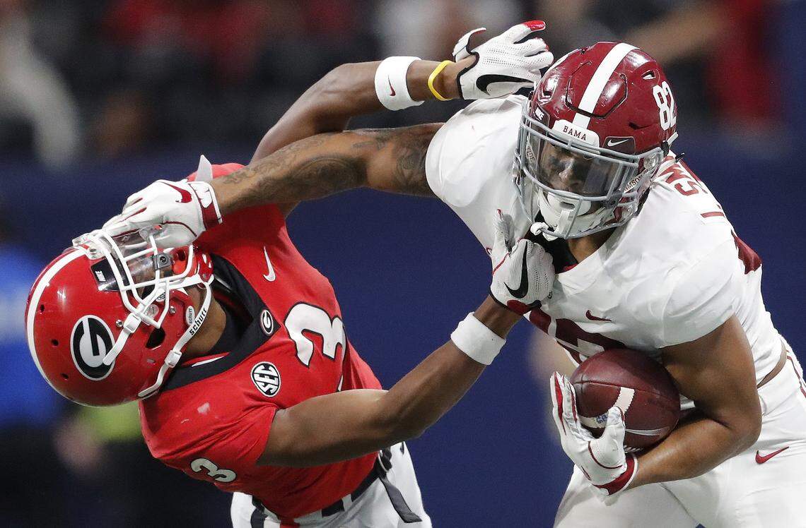 Alabama tight end Irv Smith Jr. (82), right, hits Georgia defensive back Tyson Campbell (3) in the helmet during the first half of the Southeastern Conference championship NCAA college football game, in Atlanta. Smith is a possible pick in the 2019 NFL Draft.