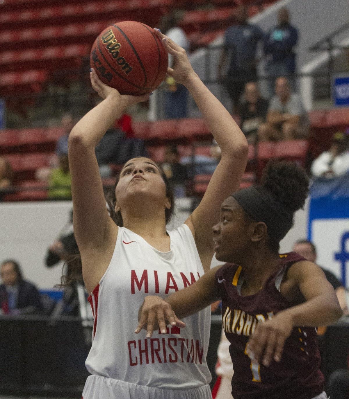 Miami Christian’s Shella Rodriguez (11) goes up for a basket as Bayshore Christian’s Tinnea Johnson (1) tries to defend during the first half of their FHSAA Girls 2-A Semifinal game at The RP Funding Center in Lakeland Monday. Miami Christian lost 53-50. February 25, 2019.