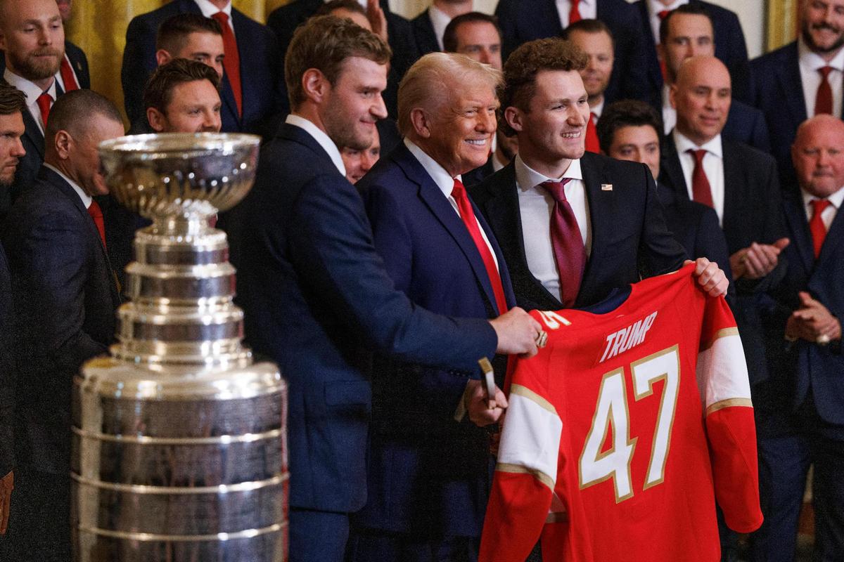 President Donald Trump is presented a Florida panthers jersey and hockey stick during an event celebrating the 2024 Stanley Cup Champion the Florida Panthers in the East Room of the White House in Washington, DC on Monday, February 3, 2025.