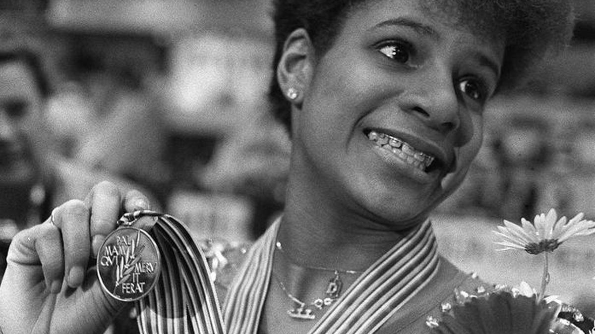 Debi Thomas from the United States is all smiles March 22, 1986 as she shows off her gold medal in Geneva. She won it for her performance in the ladies singles event of the World Figure Skating Championships.