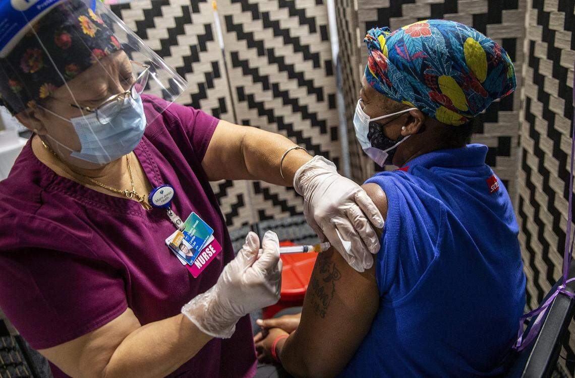 Nurse Lynnette Lee vaccinates Miami Jewish Health employee Crystal MCCutcheon with the Moderna vaccine on Thursday, Aug. 19, 2021.