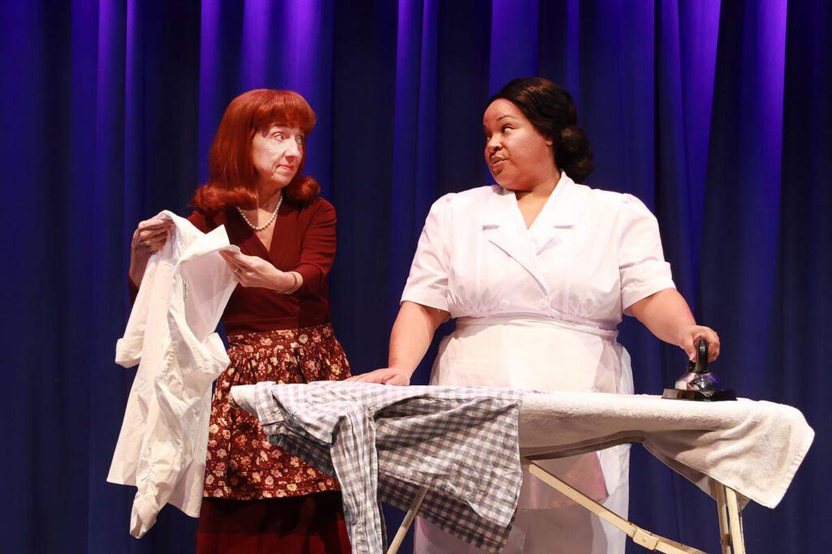Jeni Hacker, left, as stepmom Rose Stopnick Gellman, and Kareema Khouri as Caroline have words about the ironing in the Actors’ Playhouse production of “Caroline, or Change.”