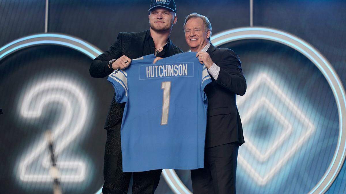 Michigan defensive end Aidan Hutchinson stands next to NFL Commissioner Roger Goodell after being selected by the Detroit Lions as the second pick in the NFL football draft Thursday, April 28, 2022, in Las Vegas. (AP Photo/Jae C. Hong )