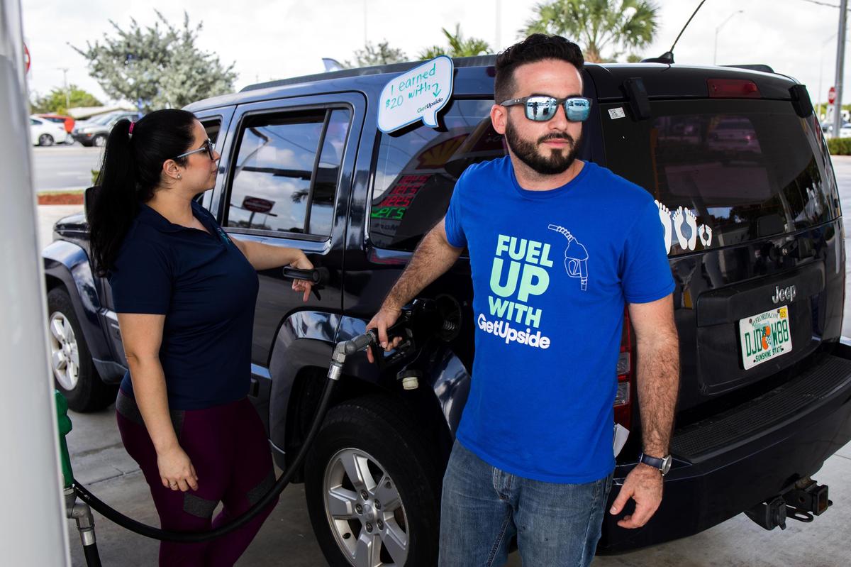 Brand ambassador Raphael Acosta pumps fuel to Elizabeth Filgueiras’ vehicle at a Shell Gas Station located in 10690 SW 8th Street which is part of the GetUpside promotion giving 750 drivers in Miami $20 worth of gas cupon on Wednesday February 12, 2020.