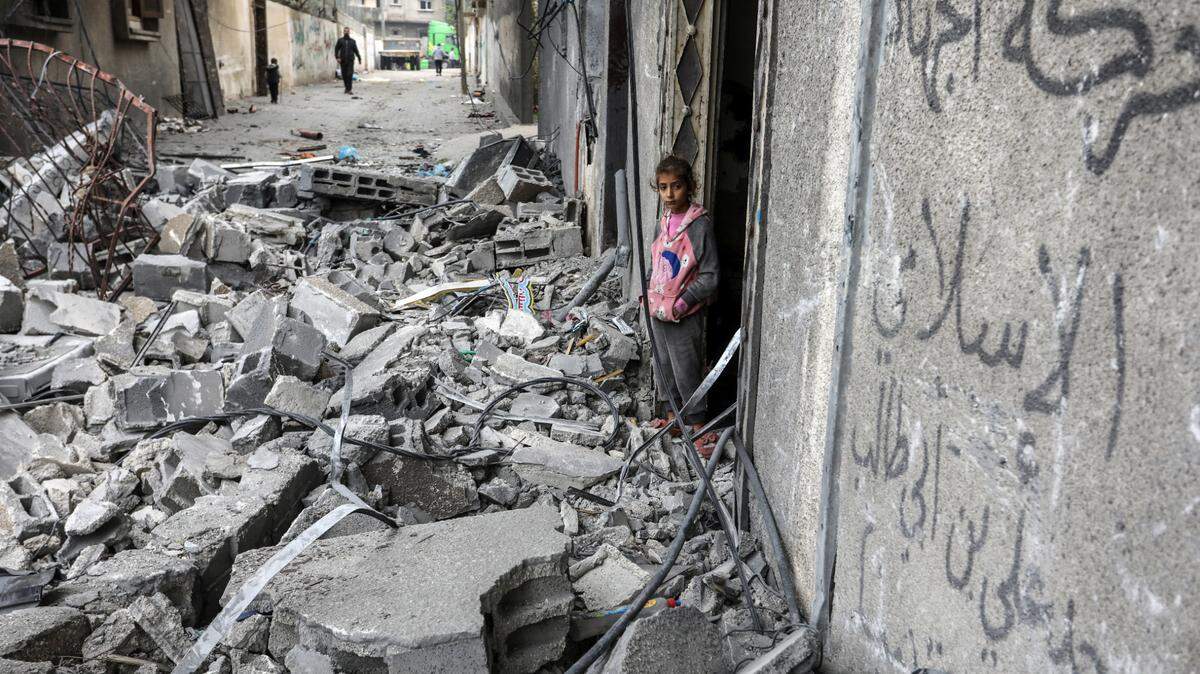 A Palestinian girl stands among the rubble of destroyed buildings after an Israeli air strike in Rafah.