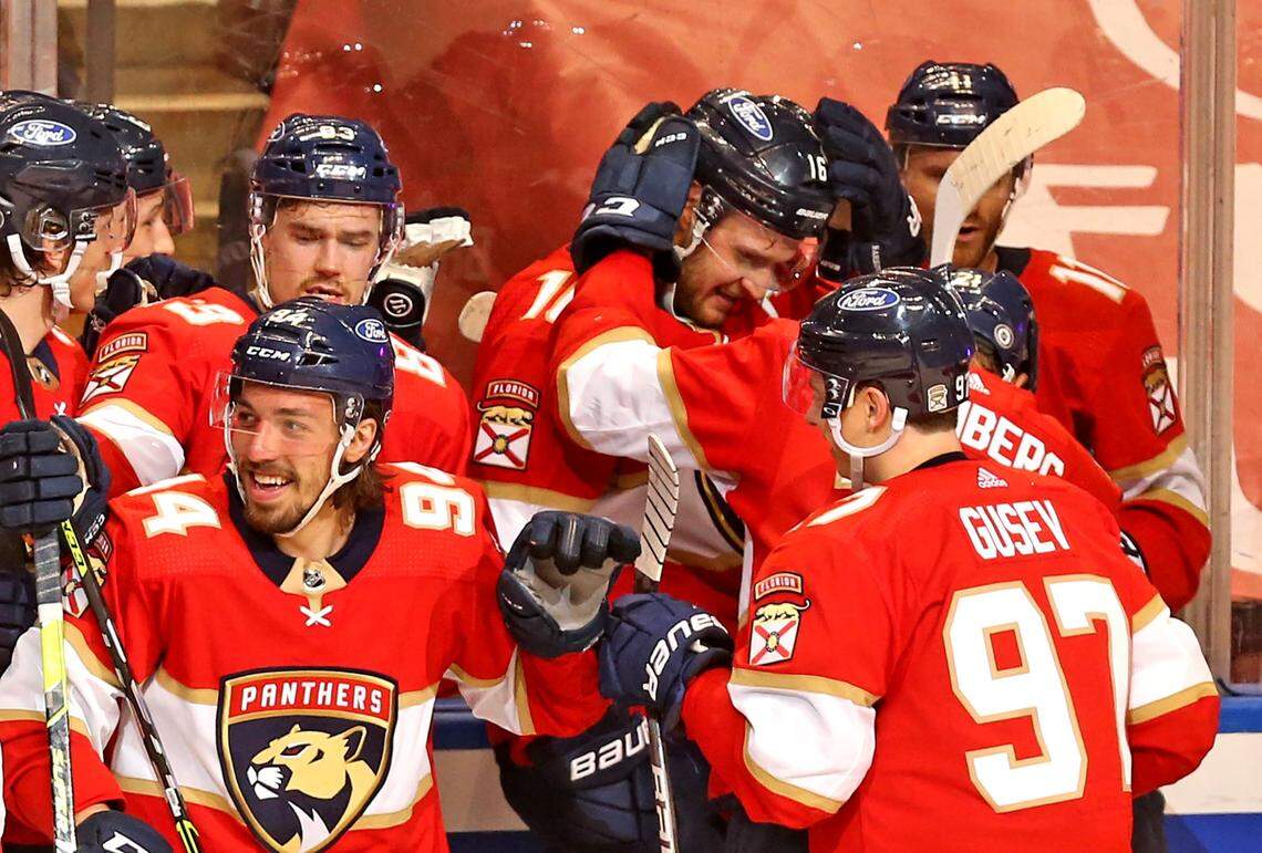 Florida Panthers players celebrate with Aleksander Barkov (16) after Barkov scored the winning goal in overtime as they defeat the Carolina Hurricanes at the BB&T Center in Sunrise, Florida, Saturday, April 24, 2021.