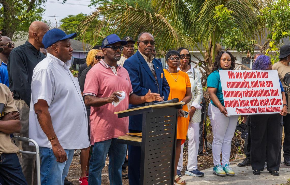 Jeffery Johnson, in the red shirt, expresses his frustration about waiting for his house to be constructed as he speaks during a press conference in Liberty City on Tuesday, March 25, 2025.