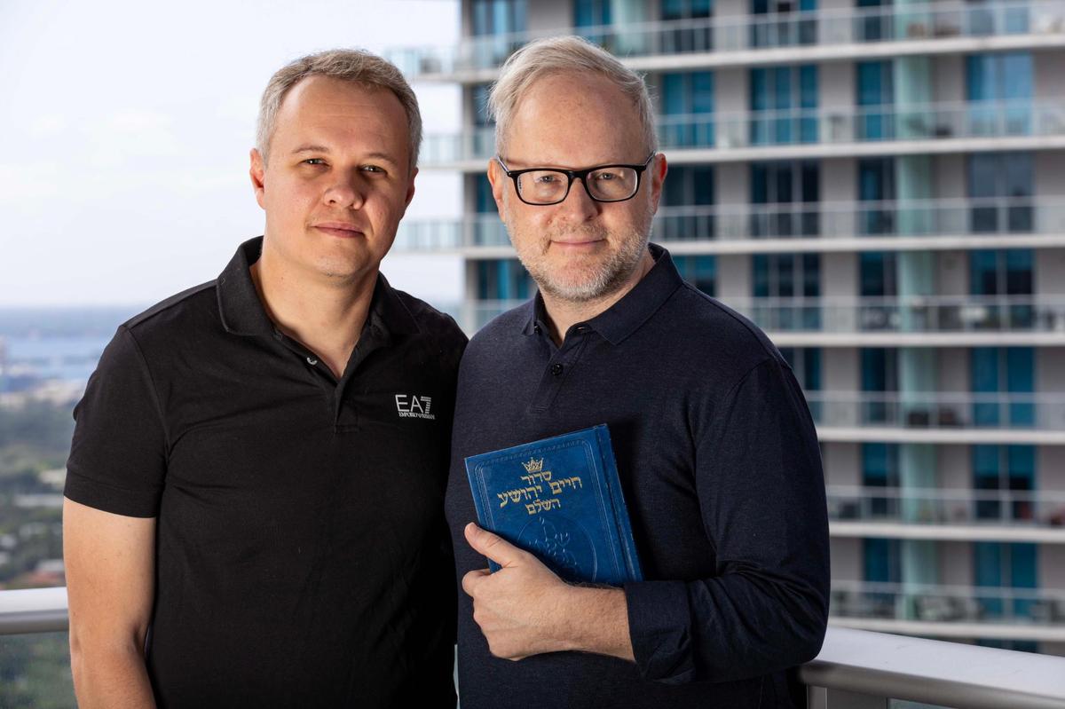 Daniel Gammerman stands alongside his partner Fernando Bertoncello on their apartment balcony overlooking the Brickell neighborhood.