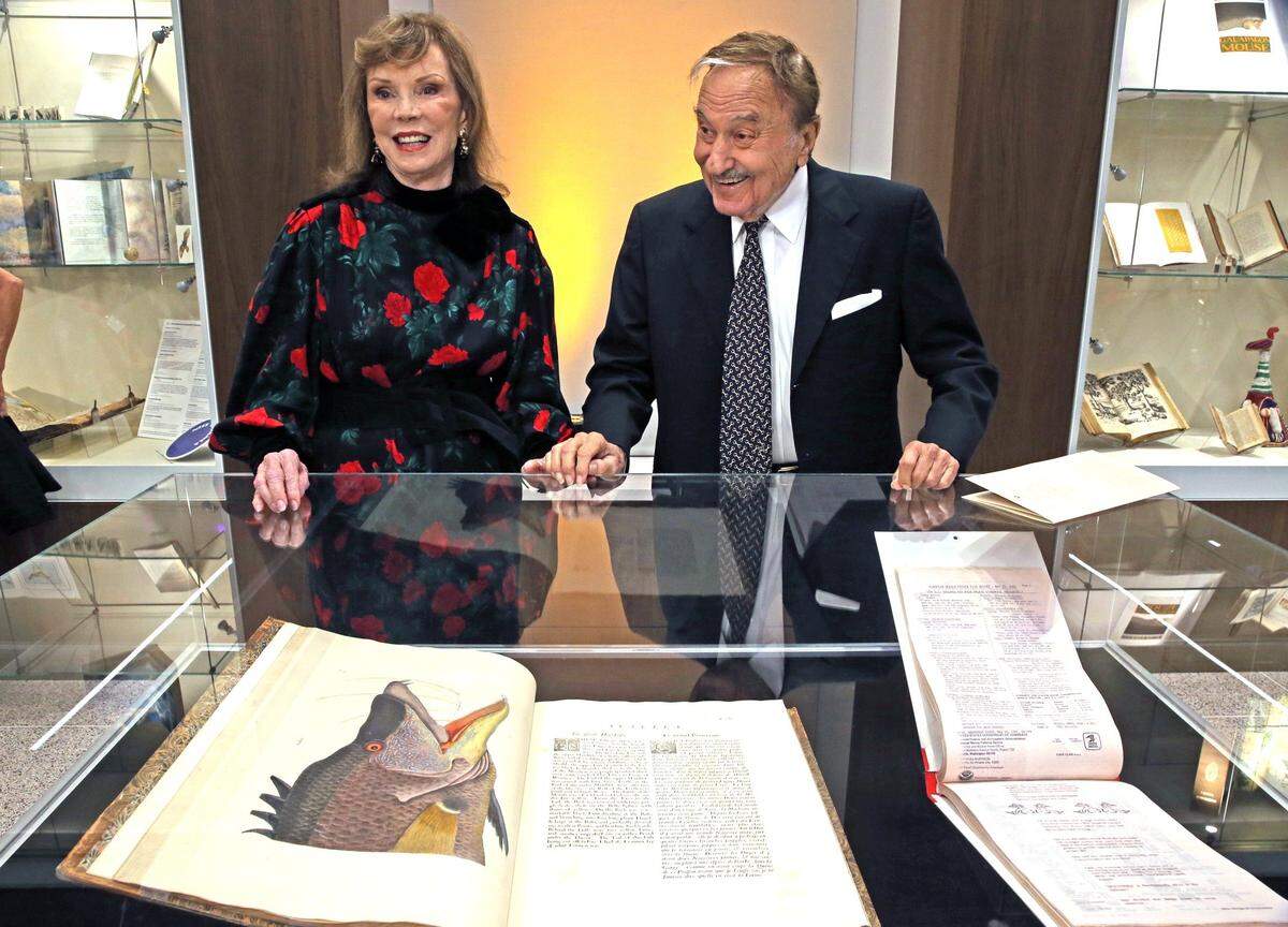 Jean and Jay Kislak stand next to the display with a book, dated 1771, by Mark Catesby, ‘The Natural History of Carolina, Florida, and the Bahamas Islands,’ at the Kislak Center at the University of Miami. The Kislaks were attending a dedication ceremony at the center.