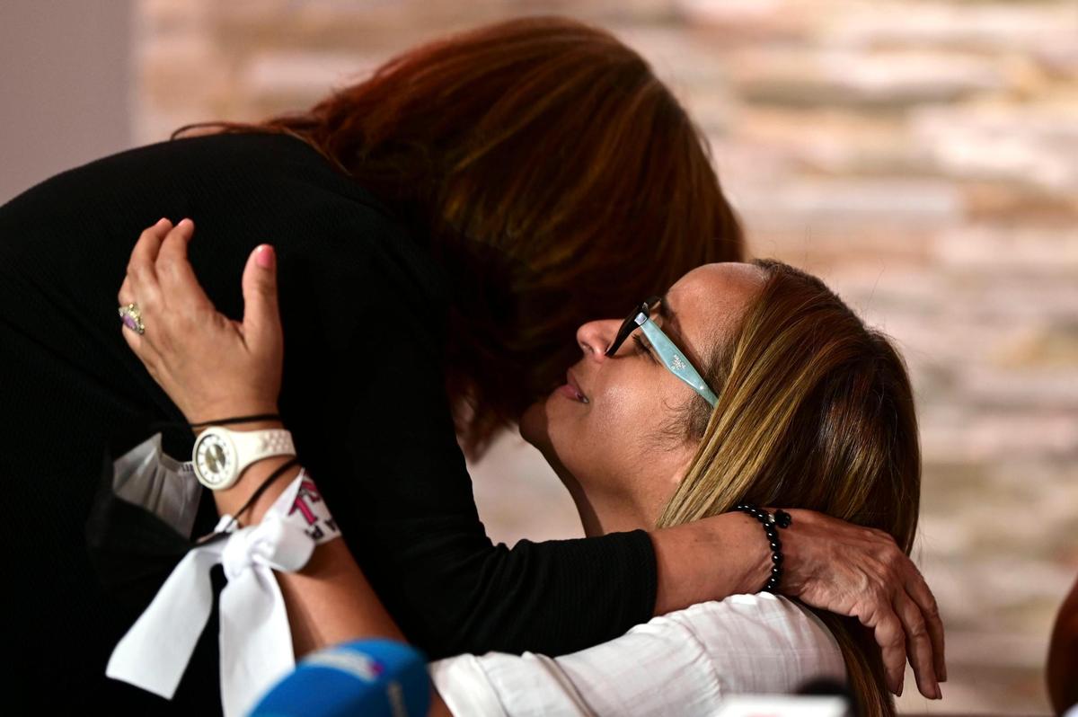 Nitza Rios, left, mother of Arelis Mercado who was brutally murdered twenty months ago, gives support to Keila Ortiz on Thursday, May 6, during a press conference at the wake of her daughter Keishla Rodriguez, whose body was found in a lagoon in San Juan, Puerto Rico.
