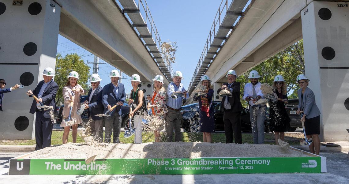Civic, political and business supporters of The Underline, the planned 10-mile linear park and trail below the Metrorail tracks, shovel sand at the University Station during a ceremonial groundbreaking for the $140 million project’s third and final phase. Billionaire Citadel founder and CEO Ken Griffin is at left, while Friends of the Underline founder and CEO Meg Daly is fifth from left.