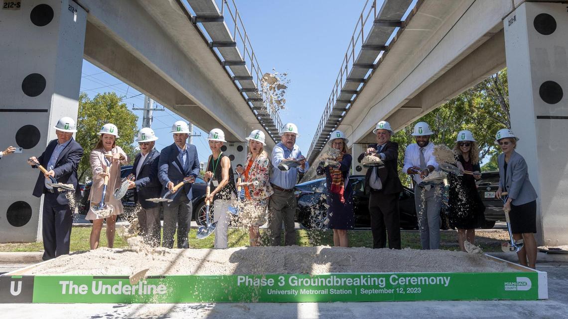 Civic, political and business supporters of The Underline, the planned 10-mile linear park and trail below the Metrorail tracks, shovel sand at the University Metrorail Station during a ceremonial groundbreaking Tuesday, Sept. 12, 2023, for the $140 million project’s third and final phase. Billionaire Citadel founder and CEO Ken Griffin, who last year moved to Miami-Dade, is at left, while Friends of the Underline founder and CEO Meg Daly is fifth from left.