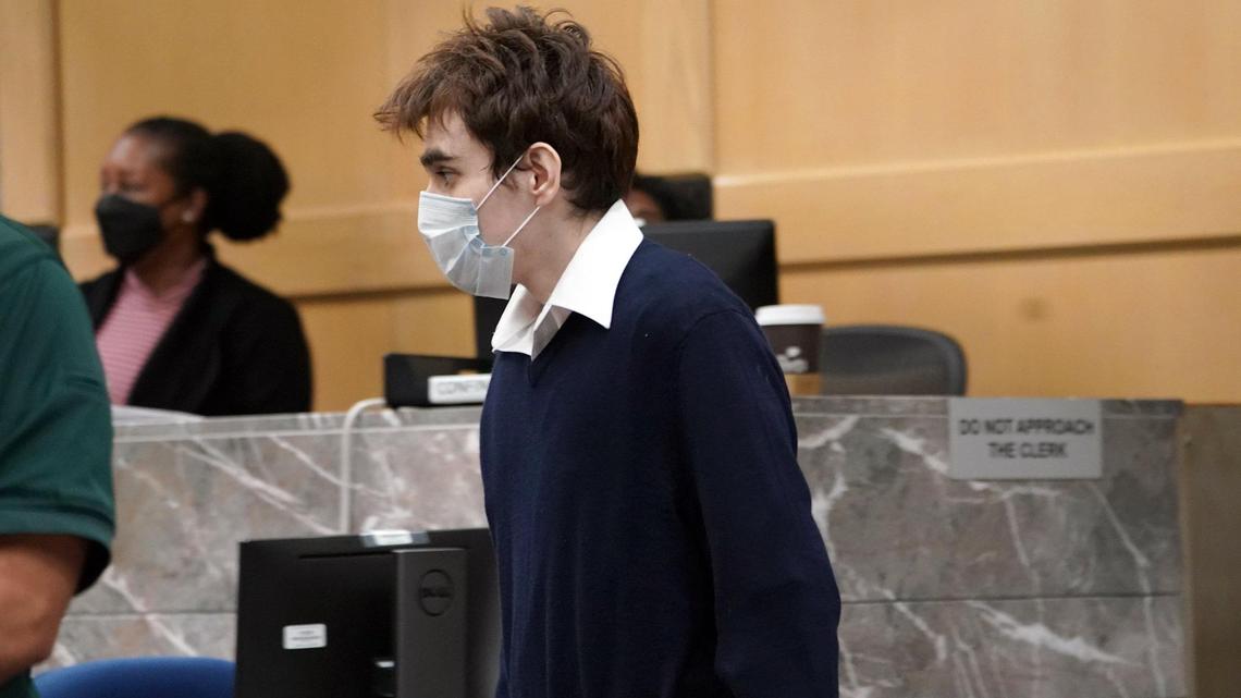 Parkland school shooter Nikolas Cruz walks to the podium to enter his guilty plea on all four criminal counts stemming from his alleged attack on a Broward County jail guard in November 2018. Cruz was at the Broward County Courthouse in Fort Lauderdale on Friday, Oct. 15, 2021. Cruz was accused of punching Sgt. Ray Beltran, wrestling him to the ground and taking his stun gun.