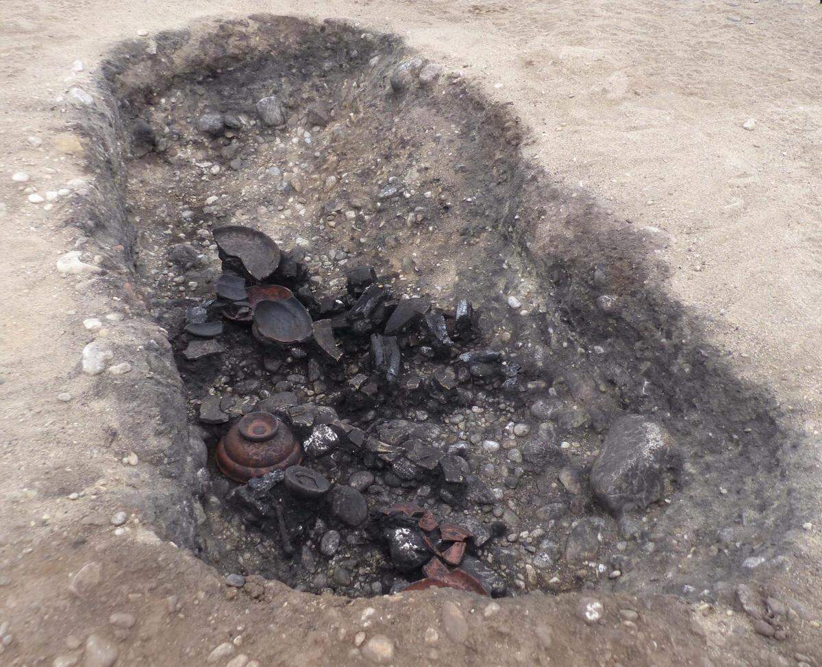 One of the pyre pits filled with ceramic artifacts.