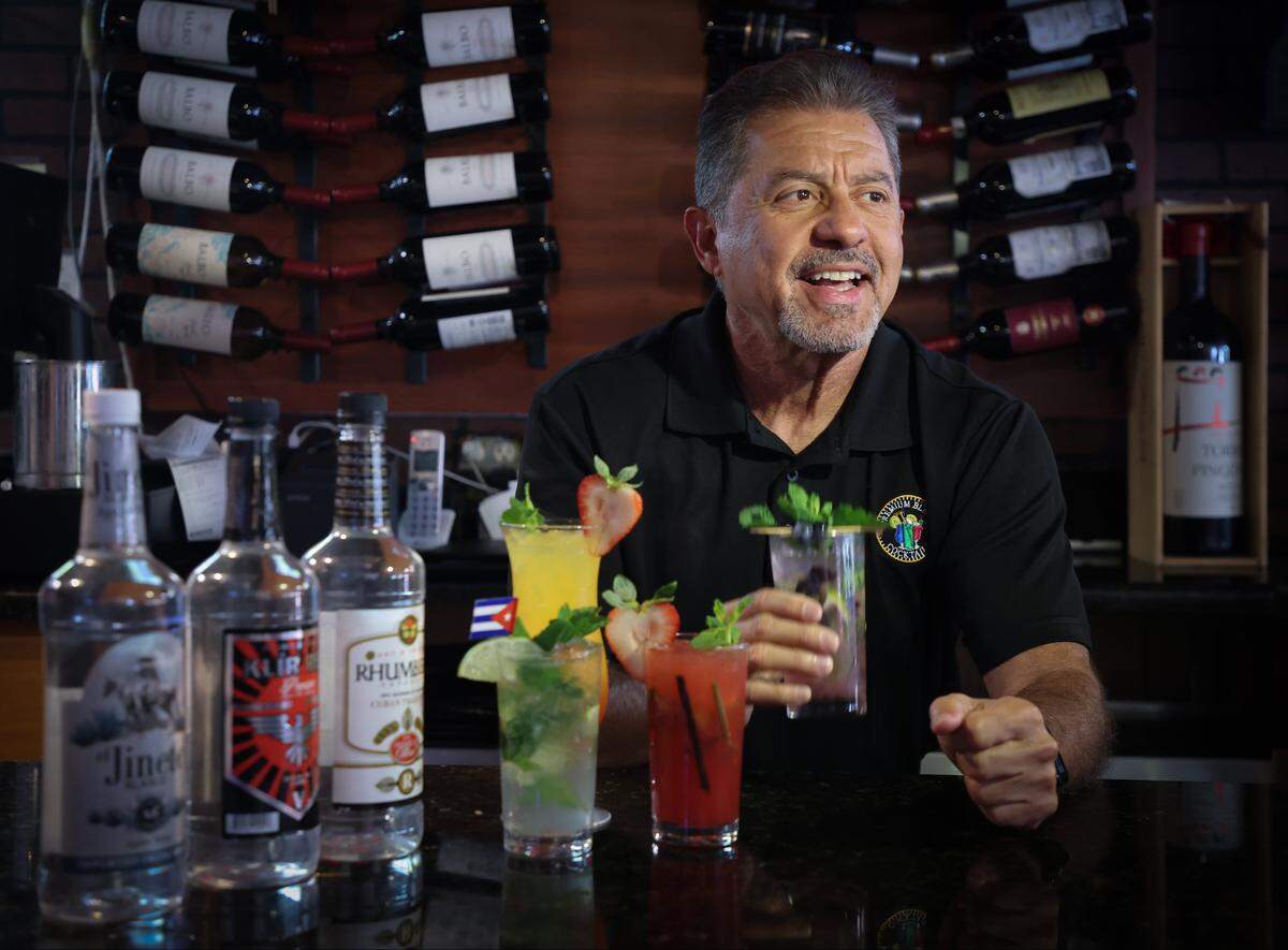 O. Gino Santos, president of Premium Blend, started a spirits business for beer and wine licensed restaurants and bars that can be used to make cocktail drinks like mojitos and other mixed drink cocktails. Santos samples a mojito at the El Cristo restaurant in Little Havana that uses his Premium Blend wine blends on Thursday, November 6, 2025 in Miami, Florida.