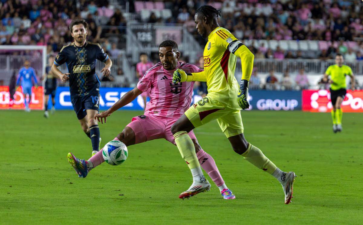 Inter Miami midfielder Yannick Bright (42) fights for possession with Philadelphia Union goalkeeper Andre Blake (18) during the second half of their MLS match at Chase Stadium on Saturday, March 29, 2025, in Fort Lauderdale, Florida.