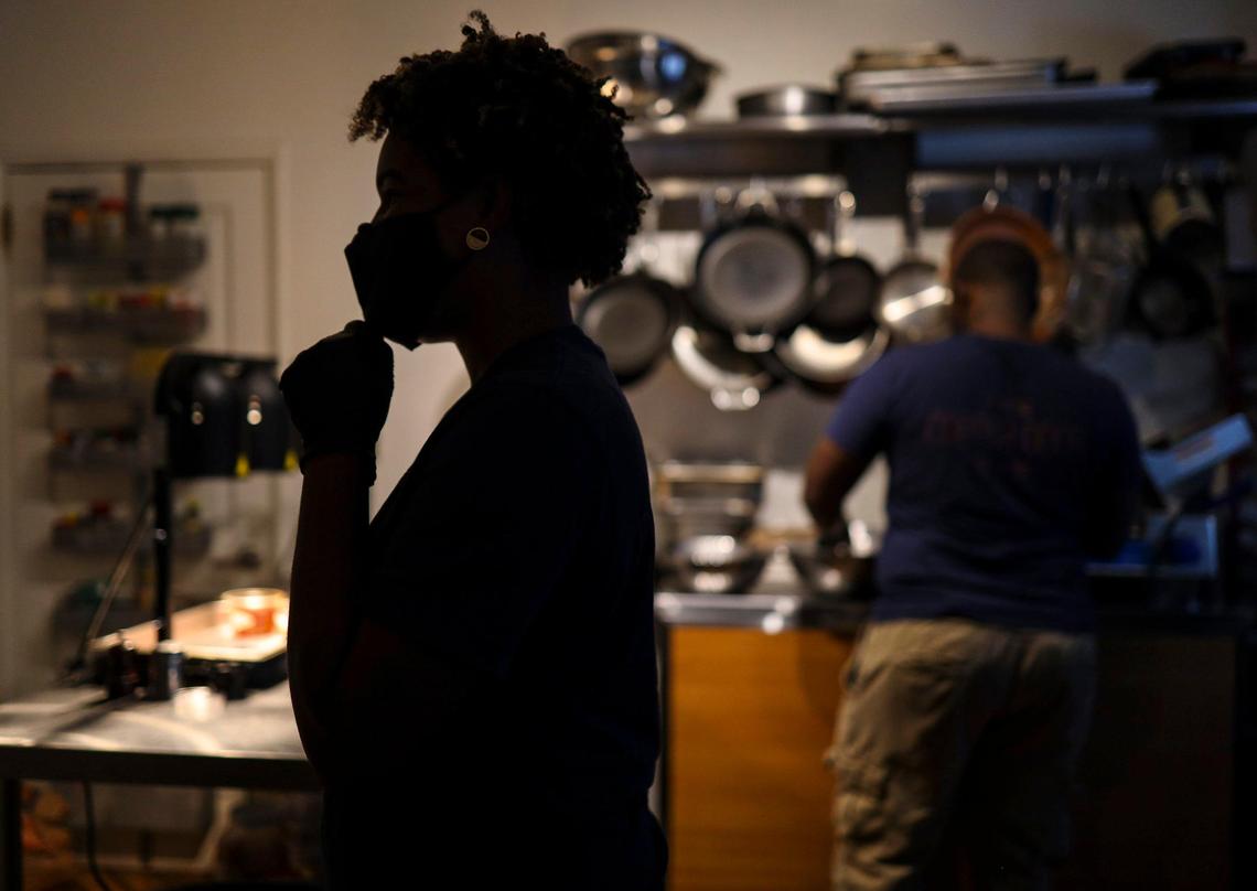 Jamila Ross, left, and Akino West, work in their small kitchen, making chicken and waffles for volunteers at Red Rooster Overtown. Their Rosie’s Cafe pop up has been their only income stream since the coronavirus forced their bed and breakfast shut.