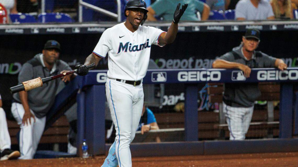 Miami Marlins left fielder Jorge Soler (12) yells to home plate umpire Ron Kulpa after he called a strike to Marlins designated hitter Bryan De La Cruz (14) during the ninth inning of a baseball game against the Philadelphia Phillies at LoanDepot Park on Sunday, July 17, 2022 in Miami, Florida.