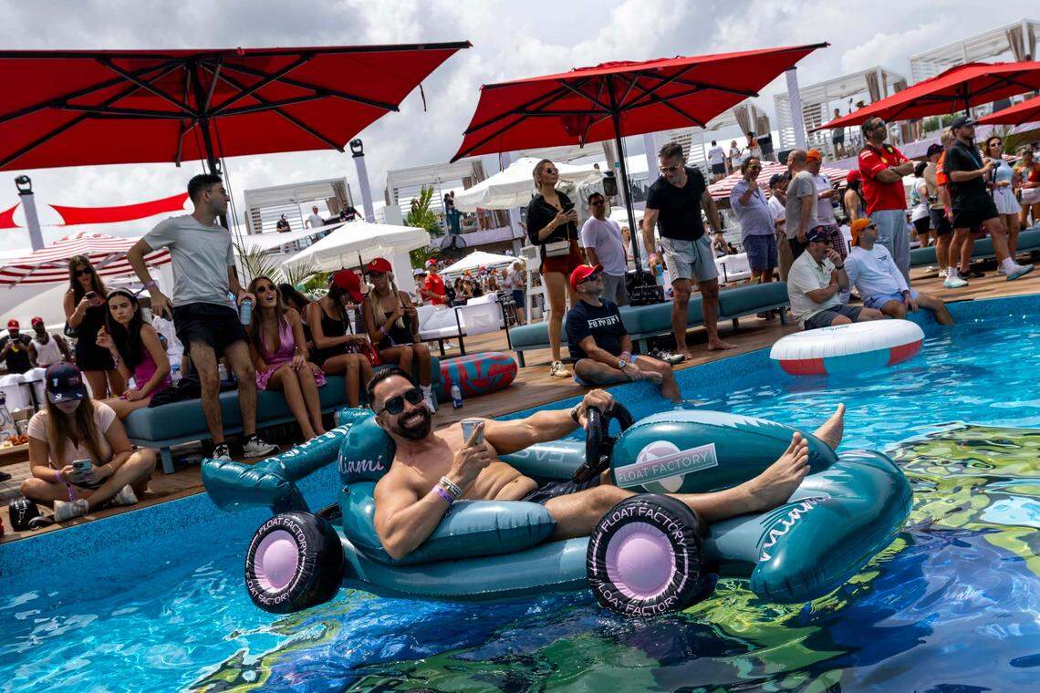Angel Ocasio sits in an inflatable F1 car in the pool at The Beach Club inside Miami International Autodrome ahead of the Formula One Miami Grand Prix at the Miami International Autodrome on Sunday, May 4, 2025, in Miami Gardens, Fla.