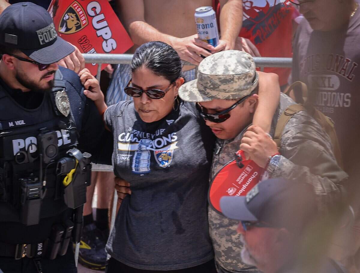 A Florida Panthers fan is assisted by a police officer and a member of the Florida State Guard during the team’s Stanley Cup championship parade on Sunday, June 22, 2025, in Fort Lauderdale, Fla.