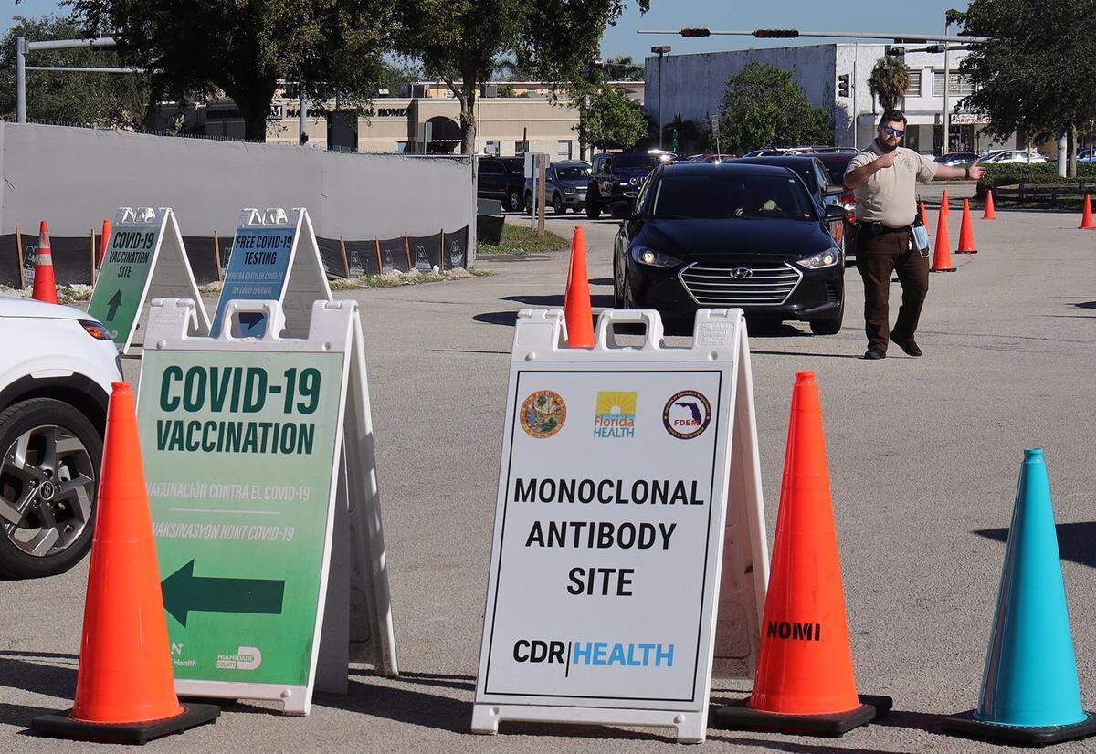 Long lines for COVID-19 testing and vaccinations are familiar sights as the omicron variant spreads. Miami-Dade police keep traffic flowing in and out of Tropical Park, a vaccination and testing site, on Thursday, Dec. 23, 2021.