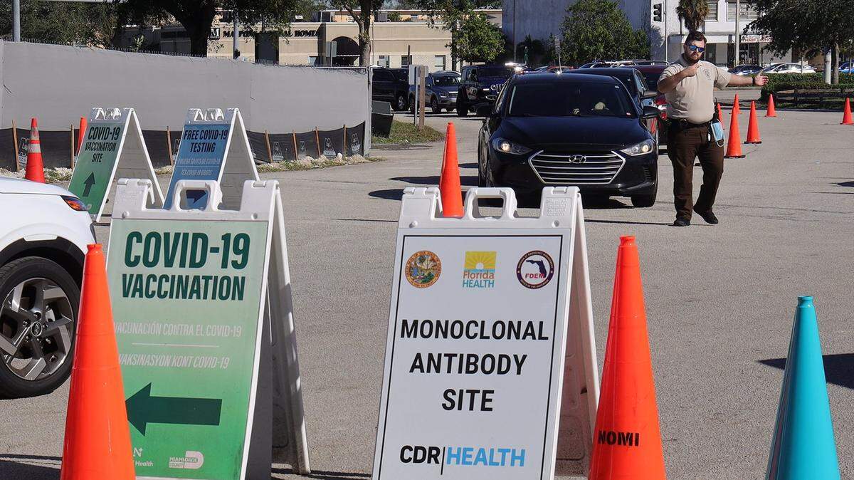 Long lines for COVID-19 testing and vaccinations are familiar sights as the omicron variant spreads. Miami-Dade police keep traffic flowing in and out of Tropical Park, a vaccination and testing site, on Thursday, Dec. 23, 2021.