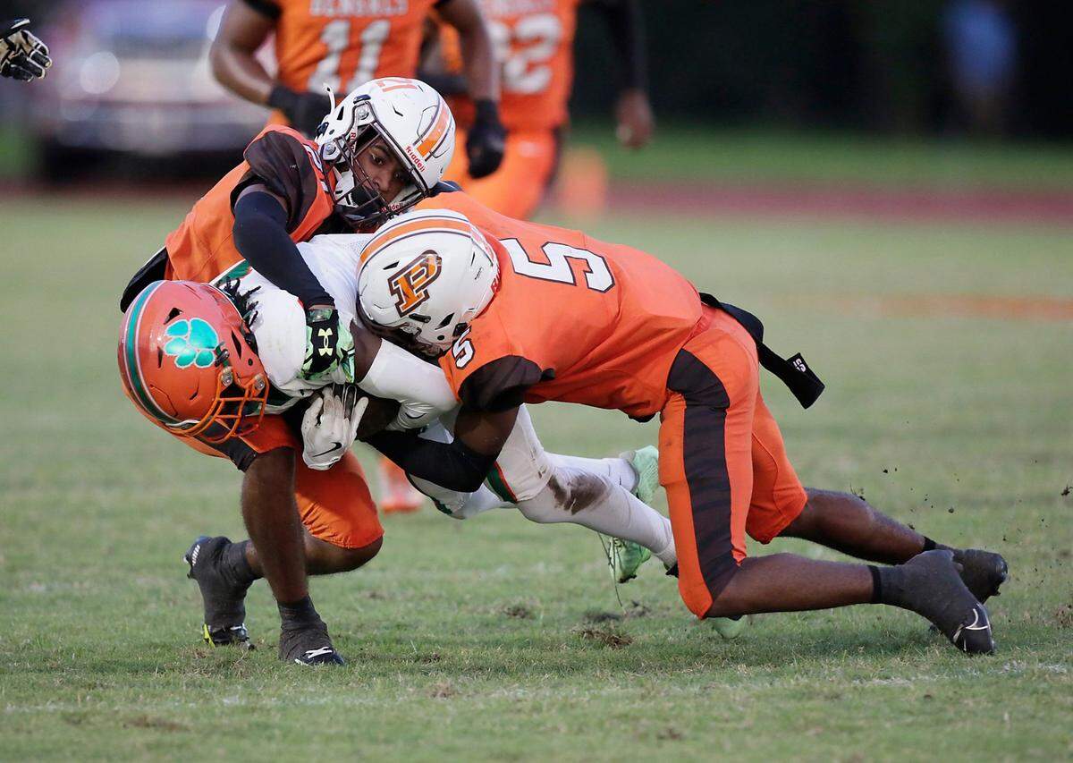 Piper Bengals defenders tackle Blanche Ely Tigers wide receiver Richard Hollis during football game on Friday, September 20, 2024 at Piper HS in Sunrise. Andrew Uloza / for Miami Herald
