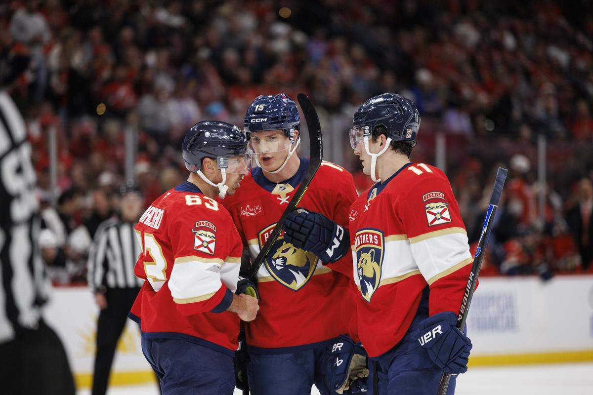 Florida Panthers center Anton Lundell (15) talks to left wing Brad Marchand (63) and right wing Mackie Samoskevich (11) during the first period of a game against the New Jersey Devils on Thursday, Nov. 20, 2025, at Amerant Bank Arena in Sunrise, Fla.