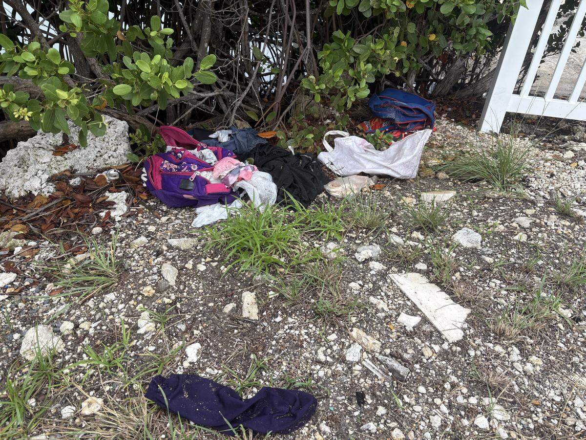 A pile of wet clothes, two children’s backpacks and some food near where the group arrived.