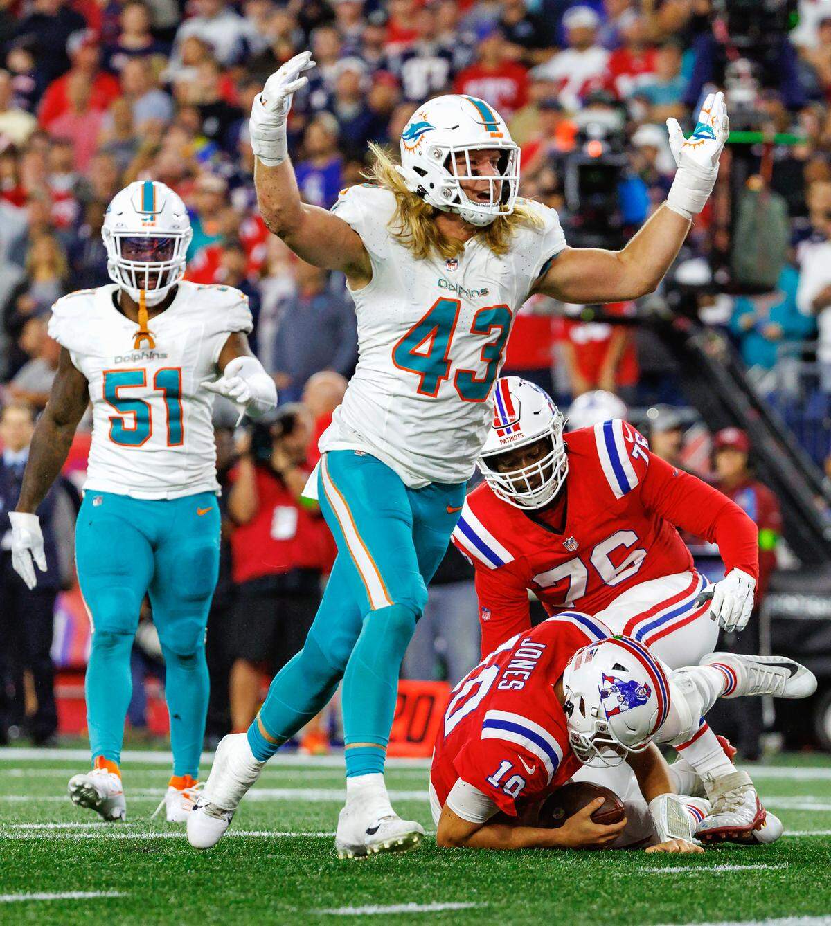 Miami Dolphins linebacker Andrew Van Ginkel (43) reacts after sacking New England Patriots quarterback Mac Jones (10) during fourth quarter of an NFL football game at Gillette Stadium on Sunday, Sept. 17, 2023 in Foxborough, MA.