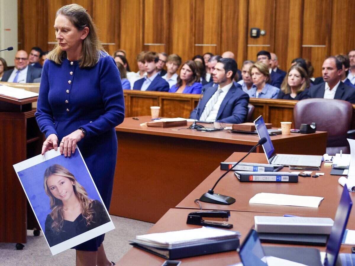 Prosecutor Laura Adams walks with a photo of Lucy Fernandez prior to giving the State's opening statement in the trial of George Pino, who is charged in connection to the crash that killed 17-year-old Lucy Fernandez. Pino's trial began on Monday, June 8, 2026.