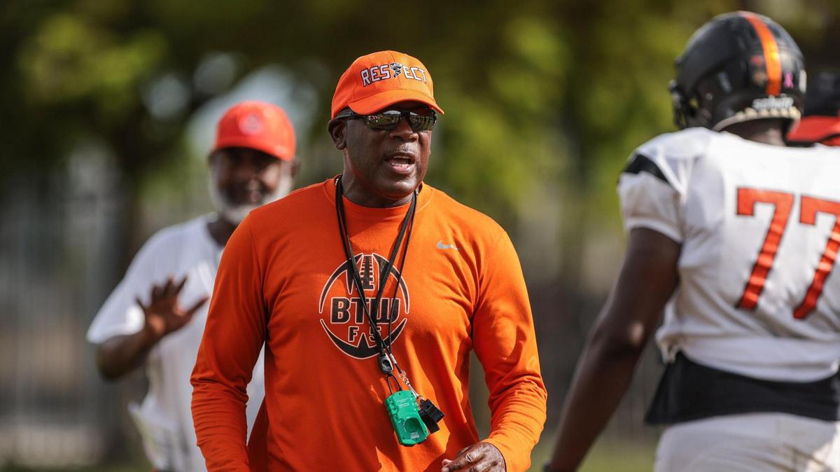 On Monday, August 8, 2022 Booker T. head football coach Tim “Ice” Harris, left, holds practice at Booker T. Washington High School in Miami, Florida.