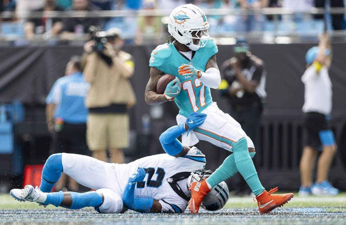 Miami Dolphins wide receiver Jaylen Waddle (17) scores a touchdown as Carolina Panthers cornerback Mike Jackson (2) defends in the second half of their NFL game at the Bank of America Stadium on Sunday, Oct. 5, 2025, in Charlotte, N.C.