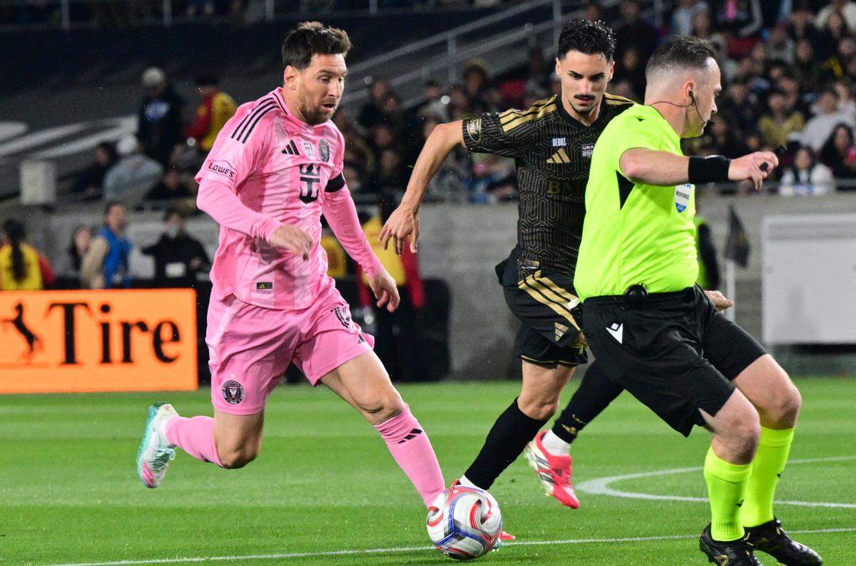 Inter Miami's Argentine forward #10 Lionel Messi (L) controls the ball against LAFC's Canadian midfielder #46 Stephen Eustaquio during the Major League Soccer opening match between Los Angeles Football Club and Inter Miami CF at the LA Memorial Coliseum in Los Angeles, on February 21, 2026. (Photo by Frederic J. Brown / AFP via Getty Images)