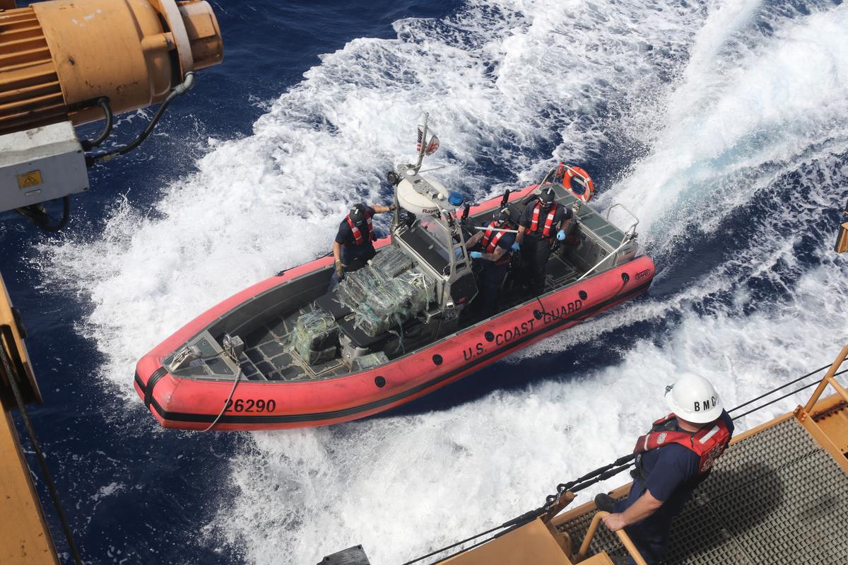 A U.S. Coast Guard Cutter Valiant law enforcement team prepares to get a small boat lifted aboard the ship after a drug interdiction about 50 miles northeast of the Dominican Republic, Feb. 17, 2025.
