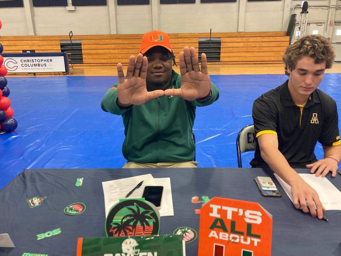 Columbus defensive lineman Daylen Russell throws up “The U” after signing with the Miami Hurricanes on Wednesday, Dec. 20, 2023.