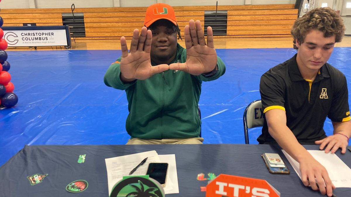 Columbus defensive lineman Daylen Russell throws up “The U” after signing with the Miami Hurricanes on Wednesday, Dec. 20, 2023.