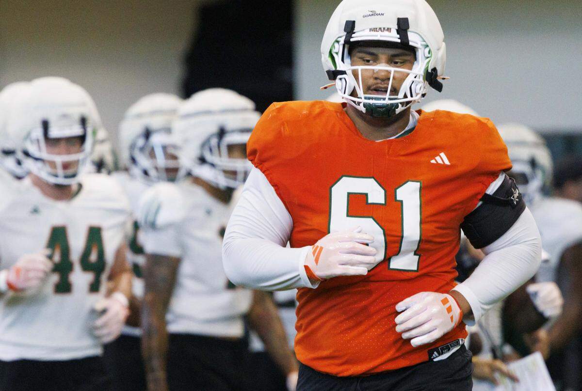 Offensive lineman Francis Mauigoa (61) runs onto the field during Miami Hurricanes football practice on Monday, Aug. 4, 2025, at University of Miami in Coral Gables, Fla. 