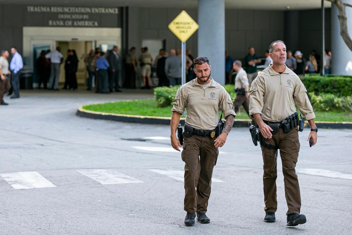 Police officers gather at Jackson Memorial Hospital’s Ryder Trauma Center on Friday, Nov. 4, 2022, in downtown Miami, Fla. Police say an off-duty officer was rushed to the hospital after his ex-girlfriend shot him in the head during a domestic dispute Friday morning in Hialeah.