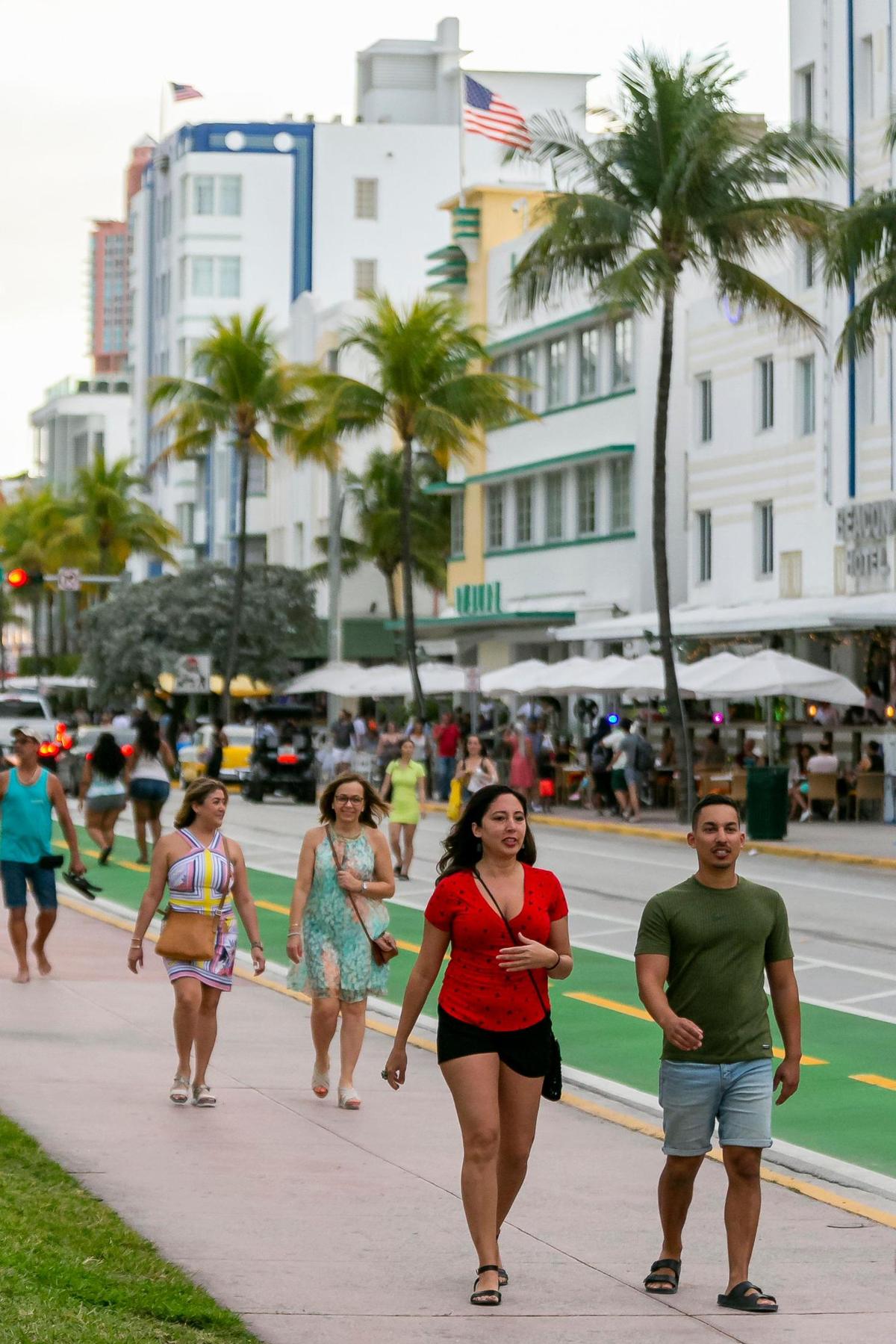 People walk down Ocean Drive in Miami Beach on Friday, Feb. 25, 2022.