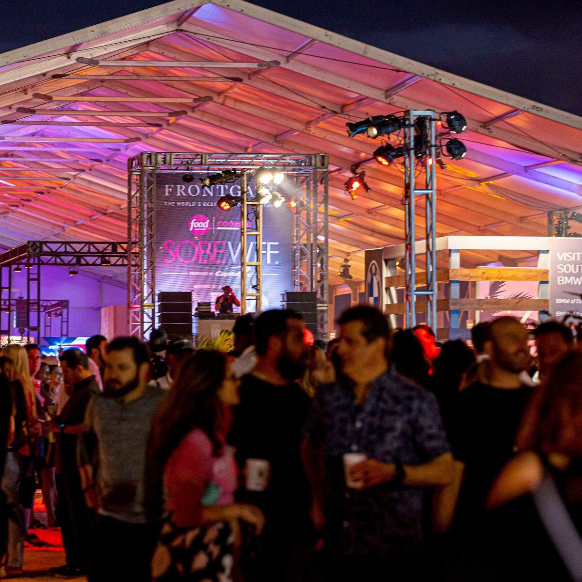 People drink and eat during South Beach Wine & Food Festival’s Burger Bash in 2022.
