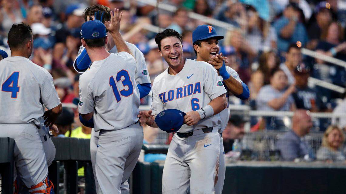 Florida's Jonathan India (6) and the Florida dugout reacts after watching replay of a score by Christian Hicks in the seventh inning of an NCAA College World Series baseball elimination game against TCU in Omaha, Neb., Saturday, June 24, 2017.