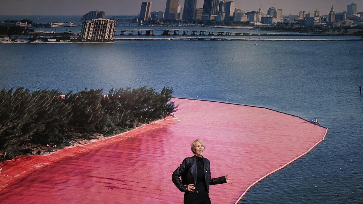 NSU Art Museum curator Bonnie Clearwater stands in front of a panoramic image from 1983 of one of the islands covered in pink by artists Christo and Jeanne-Claude. NSU Art Museum Fort Lauderdale will host an exhibition featuring newly acquired photos, models, drawings, letters, and documents related to 1983 conceptual art project, “Surrounded Islands,” which involved surrounding eleven man-made islands in Biscayne Bay with pink fabric.